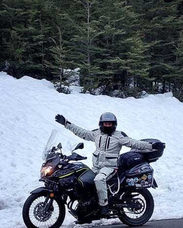 a man in a white jacket and helmet on a motorcycle